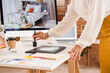 © Pixel-Shot - Female interior designer working with graphic tablet in office, closeup