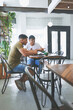 © peopleimages.com - Creative, team and men with laptop in coffee shop, content creation and planning for project on web. Cafe, remote work and people with digital assignment, video editing and collaboration with tech