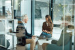© Westend61 - Team meeting in modern agency discussing business collaboration
