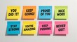 © Fatema Khanam Chy - Eight colorful sticky notes with motivational messages written on a white wall suggesting encouragement and success