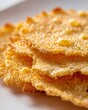© W.O.W - Crispy golden cheese crisp on white background. Baked parmesan gourmet snack. Appetizer texture, food photography of savory cracker. Italian culinary ingredient, rustic kitchen snack.