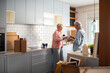 © Marko Geber - Senior couple unpacking boxes in new kitchen