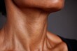 © whitestorm - Close-up of a person's neck and jawline showing detailed skin texture and contours, highlighting natural beauty.
