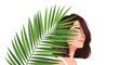 © Mariya - An illustrated woman with closed eyes is partially hidden behind a large green palm leaf on a plain white background.