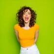© overrust - joyful young woman in vibrant green studio portrait, playful stylish female posing with carefree energy, smiling trendy woman portrait on bright green background