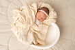 © Elena - Sleeping newborn wrapped in soft blanket