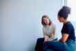 © we.bond.creations - Two diverse businesswomen smiling during an informal meeting, engaging in a pleasant conversation about work in a bright workplace