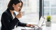 © azi - Woman works on laptop drinking coffee near window sunlight interior design