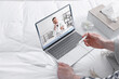 © New Africa - Telemedicine. Ill man having online video consultation with doctor via laptop at home, closeup