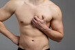 © skeronov - A young guy with an athletic build is experiencing painful sensations in the heart area. The concept of: heart disease, first aid, men's health