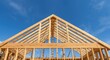 © pngking - Framing a strong pine roof structure outdoors under vivid blue skies