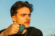 © Cavan Images - Young person with warm drink during outdoor contemplation