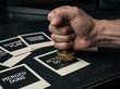 © Oma - Hand pressing a brass stamp onto an 'ACT DONE' card, symbolizing the successful completion and approval of a project task within a structured workflow