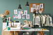 © Pixel-Shot - Interior of fashion designer's studio with workplace, drawings and clothes rack