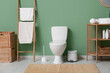© Pixel-Shot - Interior of restroom with toilet bowl, bin and ladder