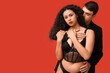 © Pixel-Shot - Sexy young couple on red background