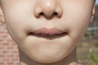 © binimin - This is the face of an Asian child with tightly closed lips.