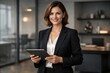 © Rawpixel.com - Confident businesswoman holding tablet.