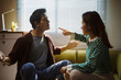 © Crystal - Asian couple having a serious argument at home, expressing anger and frustration, pointing fingers during a conflict