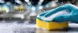 © pvl0707 - Cleaning a surface with a sponge and dish soap while snow falls softly in the background during a quiet day in a kitchen