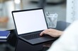 © New Africa - Man working on laptop at desk in office, closeup