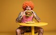© joeycheung - Man with orange wig eats giant burger tattoos visible yellow table