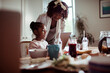 © Marko Geber - Mother helping daughter with tablet at kitchen table