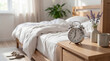 © Nicholas - Morning bedroom scene with an unmade white linen bed, retro alarm clock, and lavender flowers.