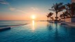 © Nasreen - Luxury outdoor infinity swimming pool overlooking sea ocean beach at sunset sunrise time, tranquil tropical resort travel destination with glowing sky reflections, serene vacation atmosphere, scenic c