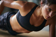 © wolfhound911 - Close-up of athletic woman holding side plank during core training, natural skin tones, subtle sweat and effort visible soft light composition