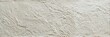 © Zaleman - A detailed view of an off-white lime plaster texture tile with a rough and uneven stucco surface. The horizontal composition highlights the grainy finish and natural trowel marks.