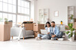 © Pixel-Shot - Young couple using laptop in rented apartment on moving day