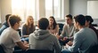© LangkahKaki - A diverse group of young adults sitting in a circle, engaged in a focused discussion or group therapy session in a bright room.