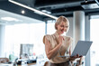 © Migma_Agency - Professional businesswoman reviewing content on a laptop