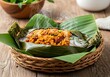 © Md Yeasin - Steaming hot traditional dish with fish and rice wrapped in banana leaves
