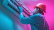 © Lady O - An air conditioning technician in a hard hat cleaning the filter.