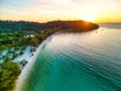 © AmazingAerialAgency - Aerial view of the soft white sands kissed by the turquoise sea, where the lush green forest meets the horizon at sunset, Preah Sihanouk, Sihanoukville, Cambodia.