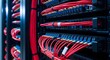 © designhunt - Close up of red fiber optic cables connected to a server. High speed data transmission and telecommunications. Network patch cables plugged into a high density fiber panel