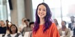 © Andrii Zastrozhnov - Young woman smiling while standing in conference audience hall