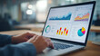 © suldev - Web analytics dashboard. Marketing data visualization. Statistical graphs and reports. Businessperson analyzing website traffic using a laptop computer.