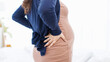 © Bangkok Click Studio - Asian young pregnant woman having lower back pain waist pain suffering from painful spasm mom backaches weight big heavy belly in last trimester of pregnancy childbirth and healthcare problems concept