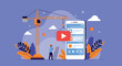 © Raisa - Construction worker on a ladder building a mobile application interface with a large crane lifting a play button icon against a blue background.