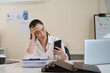© ijeab - Businesswoman stressed after checking financial information and business risk on smartphone