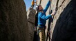 © Misalnya - Two adventurous men skillfully rock climbing a steep outdoor cliff