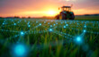 © Rhony - Green crop fields at sunset with glowing blue digital grid network representing smart farming and tractors in the background