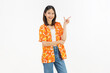 © sitthiphong - Smiling young Asian woman in colorful floral summer shirt standing and raise your hands isolated on white studio background.