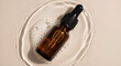 © feysa - Cosmetic serum bottle in water overhead view beauty product presentation