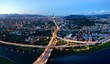 © AaronPlayStation - Aerial view over the circular interchange of Shuiyuan Expressway, Keelung Road & Fuhe Bridge in Taipei, with 101 Tower standing amid crowded buildings in Xinyi District & city lights dazzling at dusk