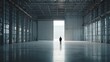 © yusran - Lone Figure Standing in Vast Empty Industrial Warehouse with Bright Light.