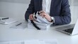 © volha_r - Business professional organizing documents at desk, managing paperwork and financial reports, working on taxes or corporate accounts with a laptop and calculator for audit preparation. Audit and taxes